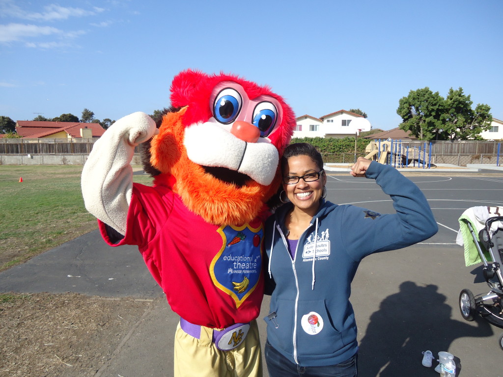 An image of a school mascot and a teacher wearing a Safe Routes to School sweatshirt