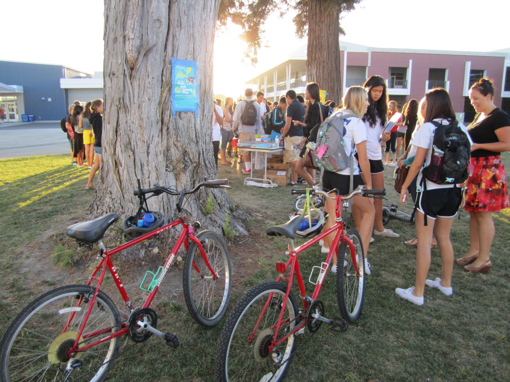 Photo of students on a school campus with their bikes