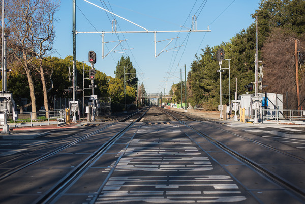 An Image of a crossing at a double track railroad. 